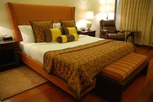 A bed or beds in a room at The Lalit Temple View