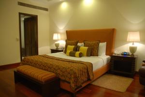 A bed or beds in a room at The Lalit Temple View