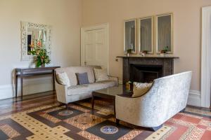 a living room with a chair and a fireplace at Oakley Hall Hotel in Basingstoke