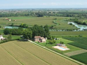 an aerial view of a house in the middle of a field at La Casa Gioconda in San Michele al Tagliamento