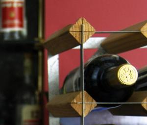 a bottle of wine sitting on top of a glass at Ilis Hotel in Olympia