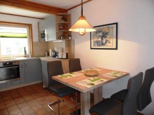 a kitchen with a table and chairs in a kitchen at ökologische Ferienanlage in Bansin +16 photos