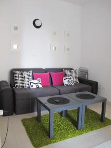 a living room with a black couch and a table at Apartment Annika in Tivat