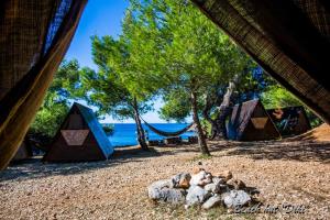 a group of tents on a beach near the water at Cast Away - Eco Resort in Zavala