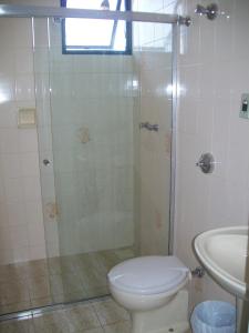 a bathroom with a shower and a toilet and a sink at Hotel Muller in Mariana