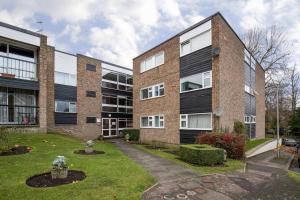 a large brick building with a courtyard at Comfy 2BR Flat with Wi-Fi in Bishop's Stortford in Bishops Stortford