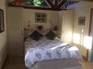 a bedroom with a large bed with a window at The Potting Shed in Warwick