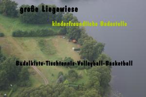 an aerial view of a park with trees and a lake at Ferienwohnungen Charlottenhof in Zechlinerhütte