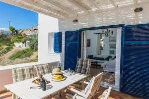 a dining room with a table with bananas on it at Villa Euphoria in Aegina, A' Marathonas bay in Egina