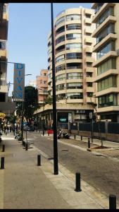 a city street with a large building in the background at Divan Hotel Apartments in Beirut