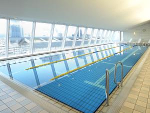 
a blue and white swimming pool in a building at Hotel Granvia Okayama in Okayama
