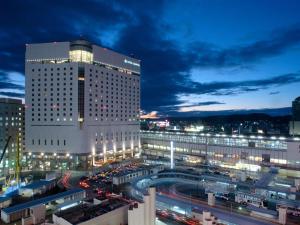 a large building with traffic in a city at night at Hotel Granvia Okayama in Okayama