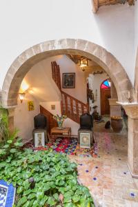 a room with a bunch of plants on the floor at Dar Rahaothello in Essaouira