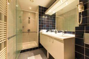 a bathroom with a sink and a shower at Inn Bruges in Bruges +41 photos