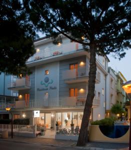 a building with a tree in front of it at Residence Perla in Misano Adriatico