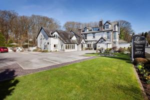 a large white house with a sign in front of it at Hawksmoor Guest House in Windermere
