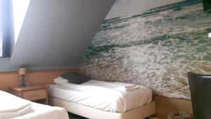 Ένα ή περισσότερα κρεβάτια σε δωμάτιο στο Hotel Velsen