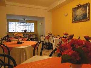 a dining room with tables and chairs and a picture on the wall at Pokoje Hotelowe Dux in Łódź +6 photos
