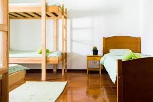 a room with two bunk beds and a table at Family House in Baleal in Ferrel