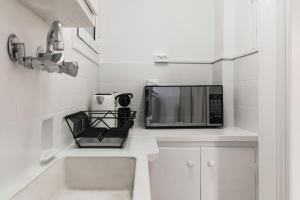 a microwave sitting on top of a kitchen counter at The Parliament Studio in Athens