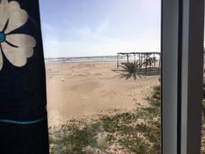 a view of the beach from a window at Apartamentos Calypso in Punta Umbría