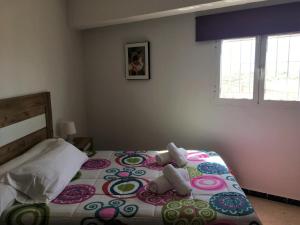 a bedroom with a bed with two teddy bears on it at Apartamentos Calypso in Punta Umbría