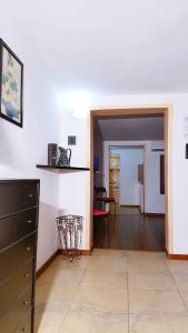 uma sala de estar com paredes brancas e piso em madeira em Home Al Rifugio em Taranto