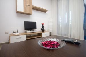 Televízia a/alebo spoločenská miestnosť v ubytovaní Style Apartment Patacona Beach