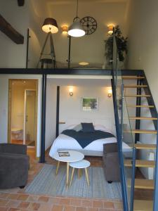 a bedroom with a bed and a staircase in a room at Chambre D' Hôtes La Lucasserie in Saumur