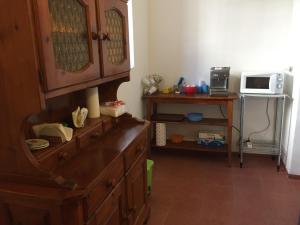 a kitchen with a wooden dresser and a microwave at B&B Ca' da Lina in Deiva Marina +4 photos