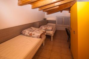 a bedroom with two beds in a room at Ostello Città di Rovereto in Rovereto +55 photos