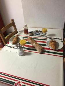 a table topped with plates of food and pastries at Auberge Bella Riva in Creysse