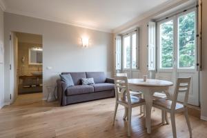 a living room with a table and a couch at Villa Italia Luxury Suites and Apartments in Arco