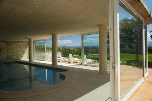 an external view of a house with a swimming pool at La Mama in El Gurb