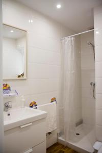 a white bathroom with a shower and a sink at Infanta Beatriz in Sanlúcar de Barrameda +37 photos