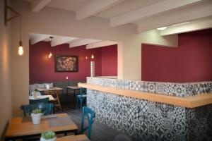 a restaurant with red walls and tables and chairs at Casa Calila in San José Iturbide