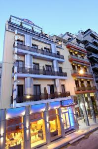 a large white building with a lot of windows at Anita Hotel in Piraeus