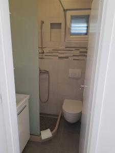 a small bathroom with a toilet and a shower at Peric Rooms Dubrovnik in Dubrovnik