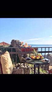a tray of fruit on a table on a balcony at Apartments Zuto in Ulcinj