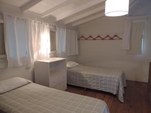 Una cama o camas en una habitación de Puerto de Lilas