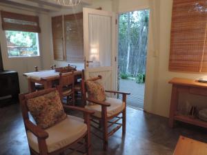 a dining room with a table and chairs and windows at Puerto de Lilas in Las Gaviotas