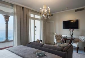 a living room filled with furniture and a large window at Hotel Casa Vilella 4* Sup in Sitges