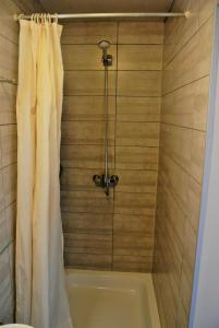 a bathroom with a tub with a shower curtain at Hotel Tropicana in Blankenberge