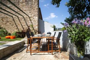 a wooden table and chairs on a patio at Duplex Pombal in Santiago de Compostela
