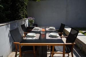 サンティアゴ・デ・コンポステーラにあるDuplex Pombalのテーブル(椅子付)、黒いテーブル、皿、ボウル