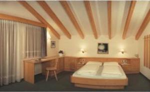 Postel nebo postele na pokoji v ubytování Hotel Vajolet