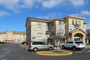 two cars parked in a parking lot in front of a building at Extended Stay America Suites - Columbus - Tuttle in Dublin