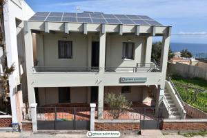 uma casa com painéis solares por cima em Green Point Home Chios em Vrontádos