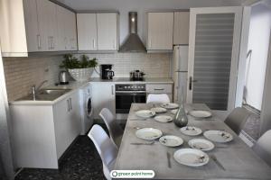 a kitchen with a table with plates on it at Green Point Home Chios in Vrontádos
