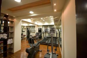 a gym with treadmills and ellipticals in a room at Capsis Hotel Thessaloniki in Thessaloniki